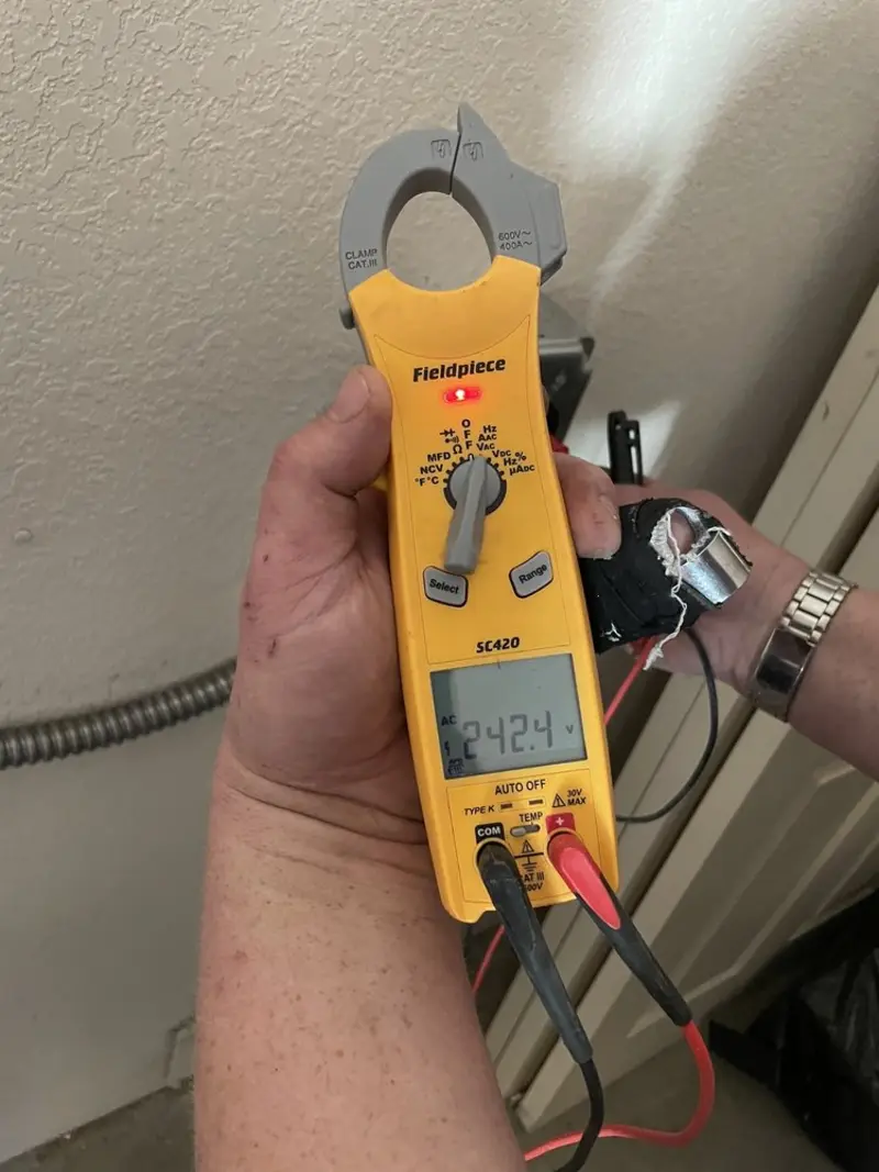 Voltage testing with clamp meter during Recessed Lighting Installation in Moundville